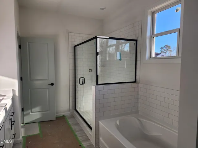 a bathroom with a bathtub and shower