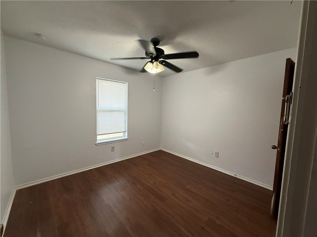 902 St Timothy Street Corpus Christi, TX 78418 - Photo 11 of 24 wooden floor in an empty room with a window