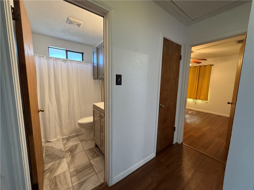 902 St Timothy Street Corpus Christi, TX 78418 - Photo 12 of 24 a bathroom with a sink and a glass door shower