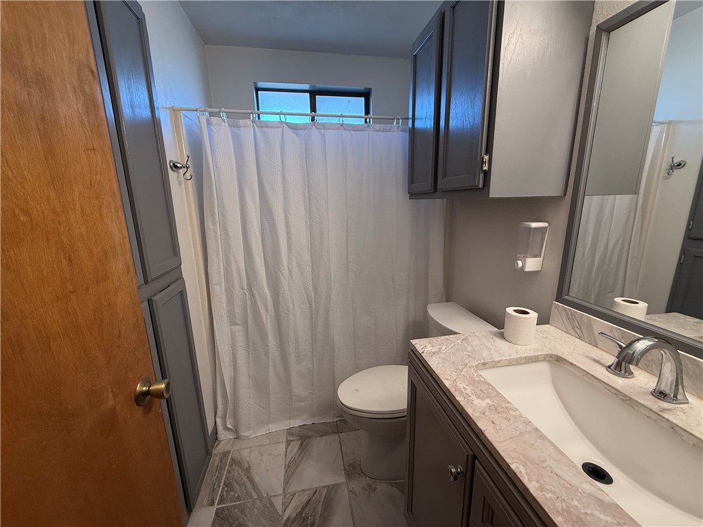 902 St Timothy Street Corpus Christi, TX 78418 - Photo 13 of 24 a bathroom with a granite countertop sink toilet and shower