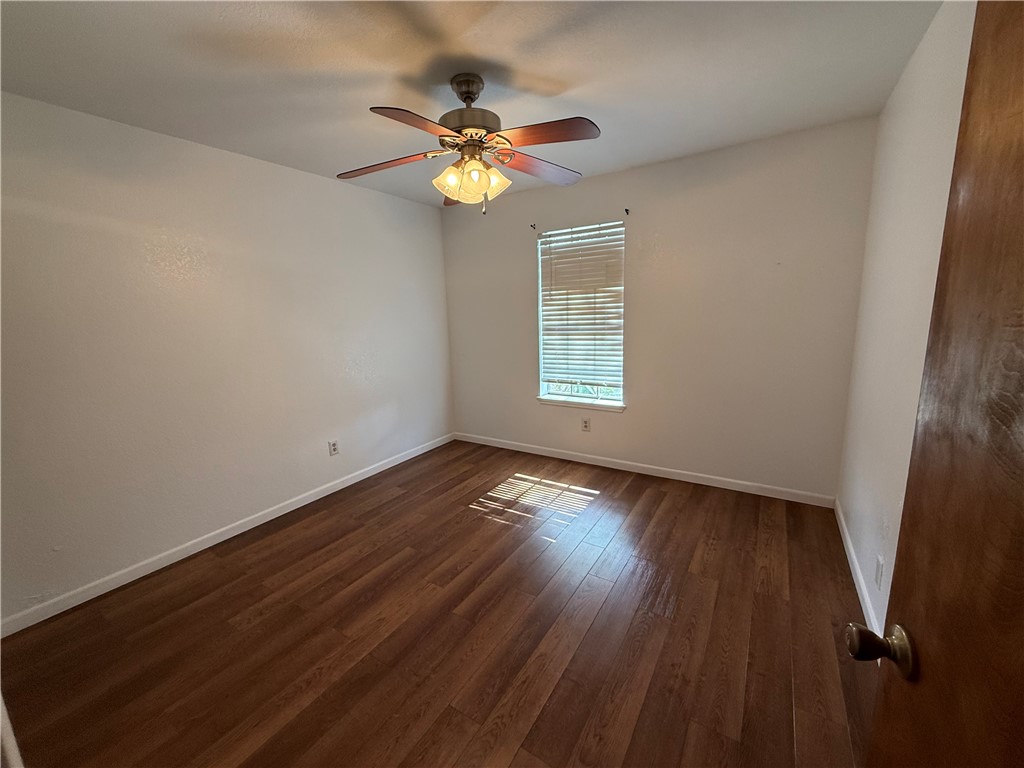 902 St Timothy Street Corpus Christi, TX 78418 - Photo 16 of 24 a view of an empty room with wooden floor and a window