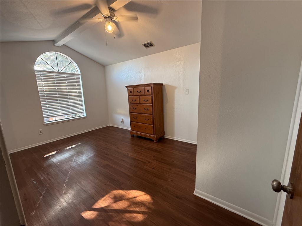 902 St Timothy Street Corpus Christi, TX 78418 - Photo 18 of 24 an empty room with wooden floor chandelier fan and windows
