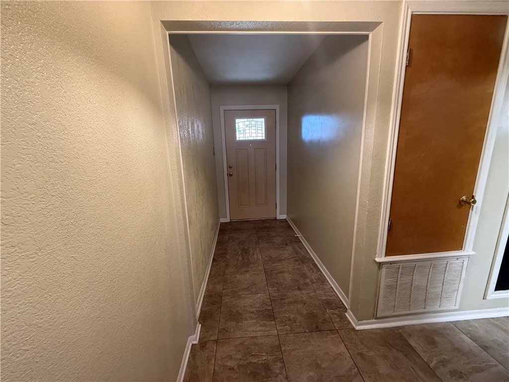 902 St Timothy Street Corpus Christi, TX 78418 - Photo 3 of 24 a view of a hallway with wooden floor and stairs