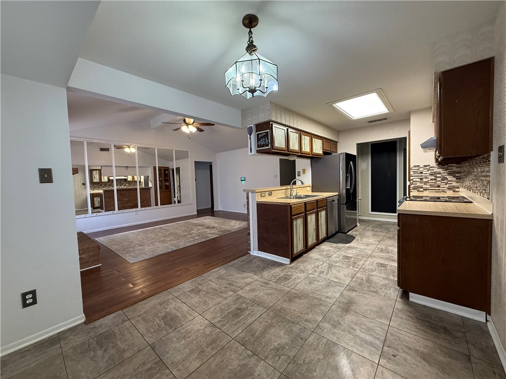902 St Timothy Street Corpus Christi, TX 78418 - Photo 7 of 24 a large kitchen with kitchen island granite countertop a stove oven and a sink with granite countertops