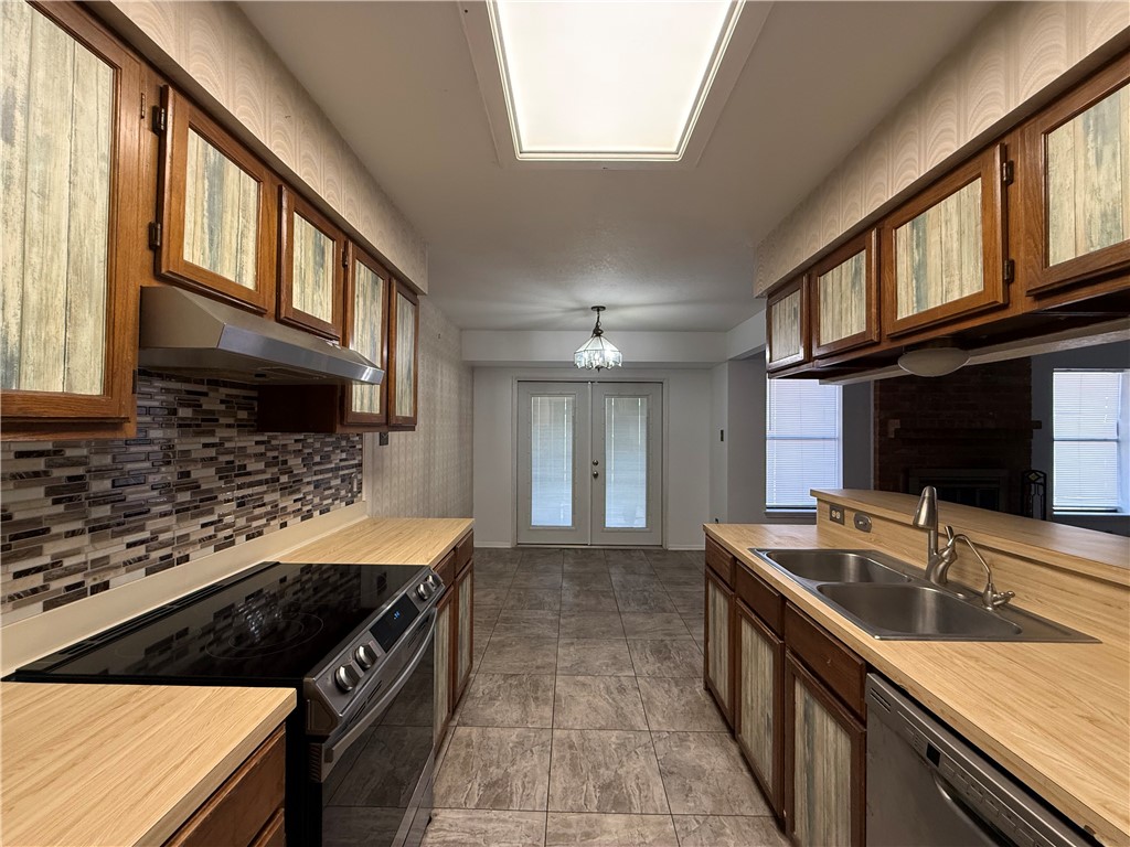 902 St Timothy Street Corpus Christi, TX 78418 - Photo 8 of 24 a kitchen with stainless steel appliances granite countertop a sink stove and cabinets
