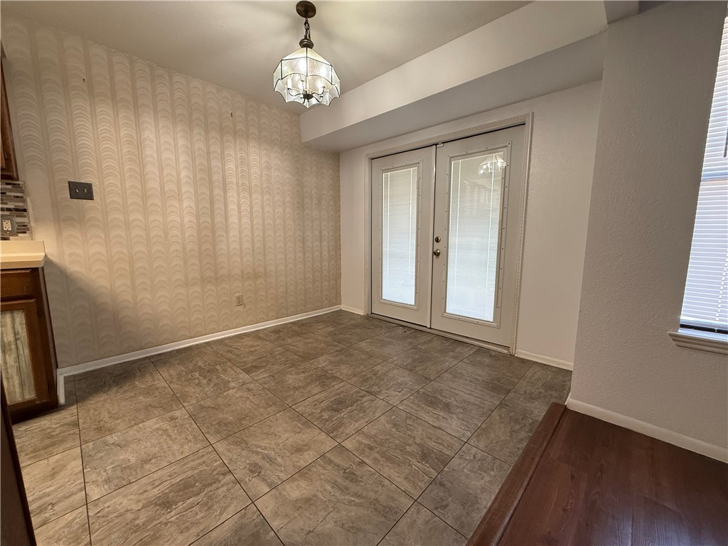 902 St Timothy Street Corpus Christi, TX 78418 - Photo 9 of 24 an empty room with wooden floor and windows