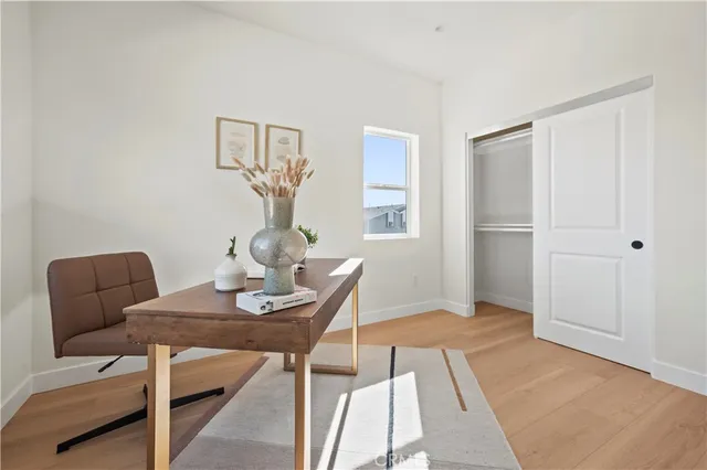 a bedroom with a large bed and a potted plant