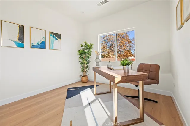 a living room with furniture and a potted plant