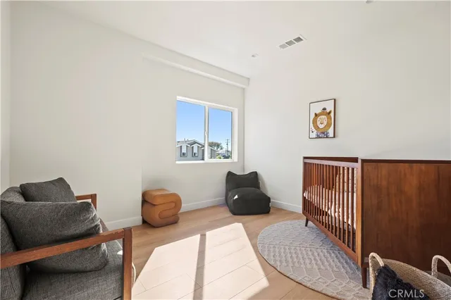 a view of a room with wooden floor and bench