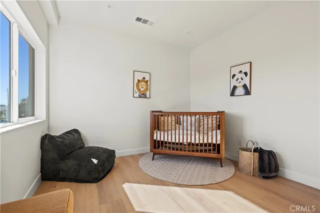 a view of a room with wooden floor and furniture