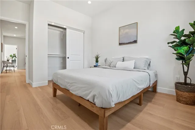 a kitchen with stainless steel appliances a white table a potted plant and a window