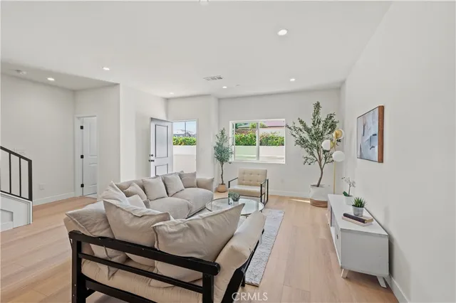 a bedroom with a large bed and a potted plant