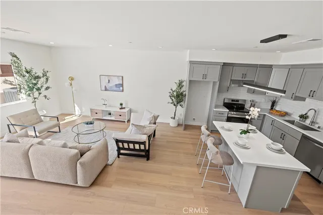 a kitchen with stainless steel appliances a refrigerator sink and microwave