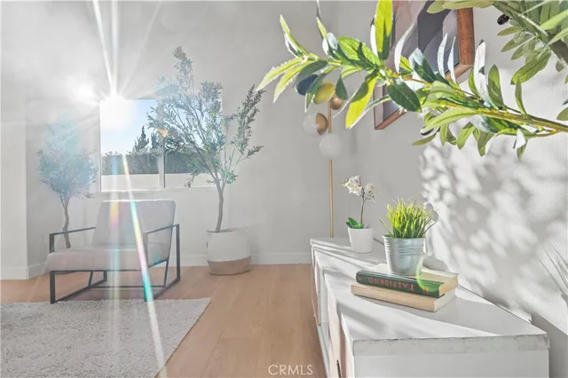 a view of an empty room with wooden floor and window