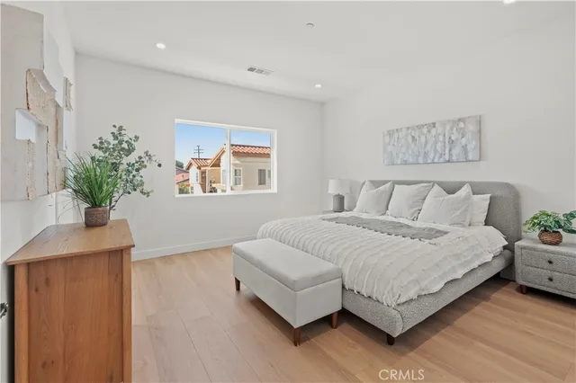 an empty room with wooden floor and window