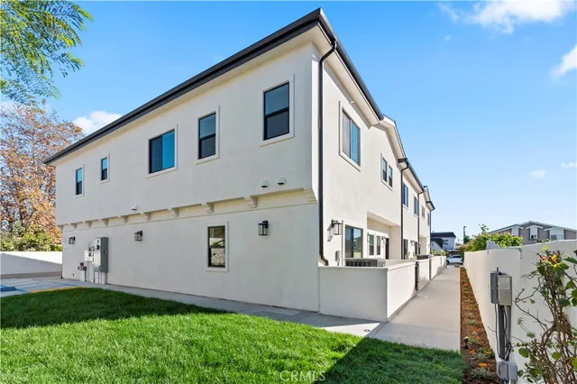 a kitchen with stainless steel appliances kitchen island granite countertop a refrigerator and a stove top oven