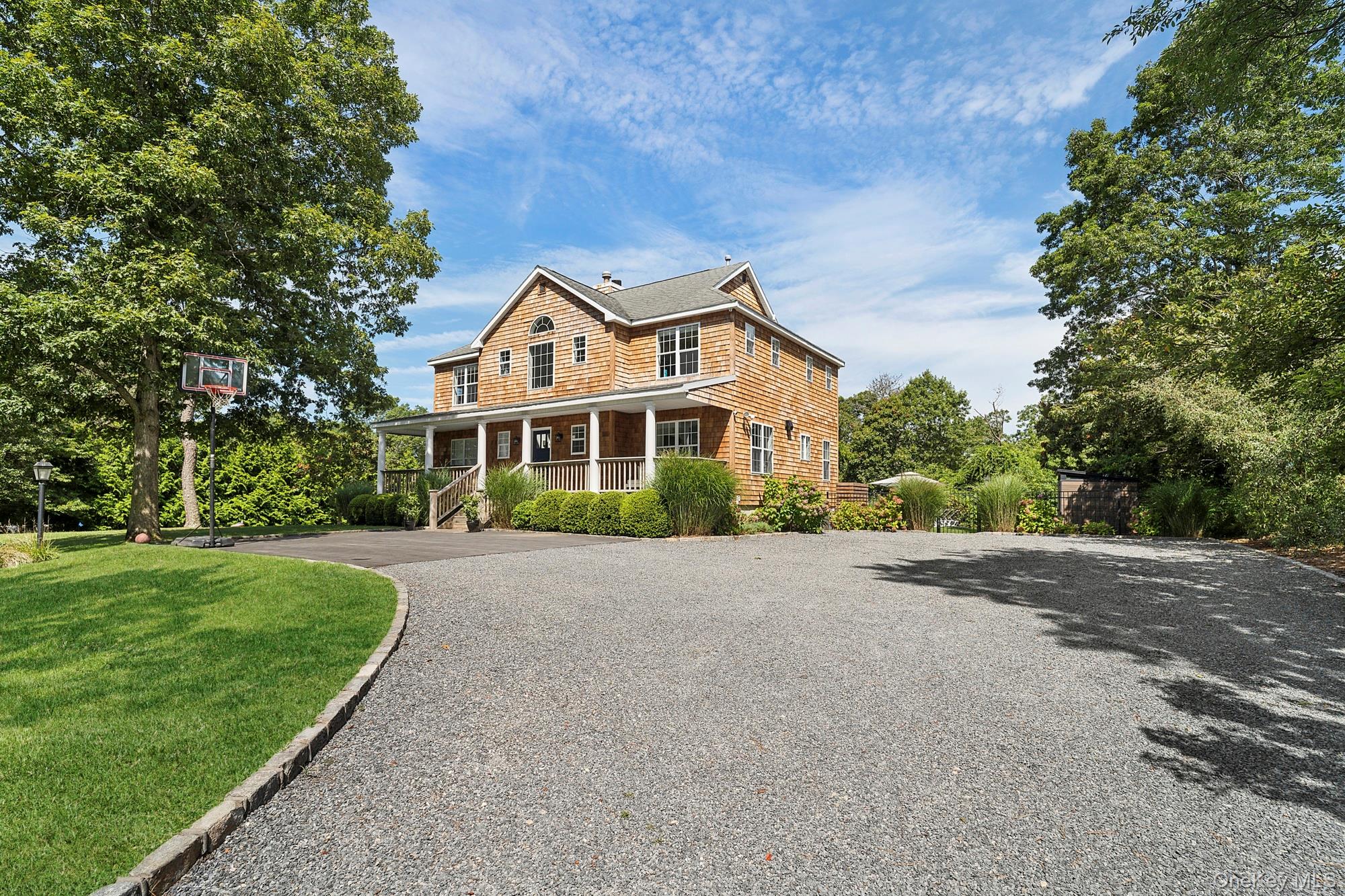 71 Old Canoe Place Road Hampton Bays, NY 11946 - Photo 1 of 34 a front view of a house with a yard