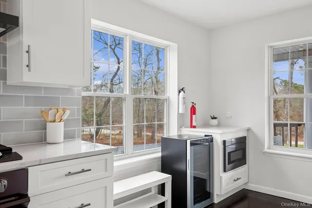 a kitchen with stainless steel appliances a stove and white cabinets