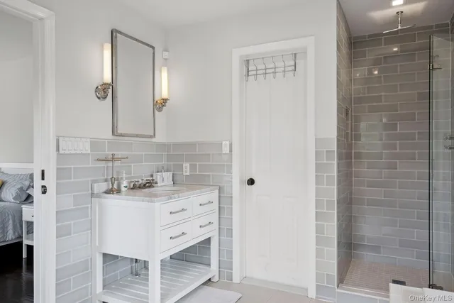 a bathroom with a sink vanity and a mirror