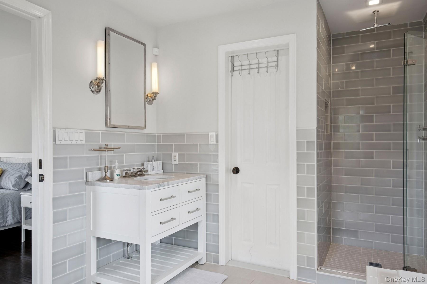 71 Old Canoe Place Road Hampton Bays, NY 11946 - Photo 17 of 34 a bathroom with a sink vanity and a mirror