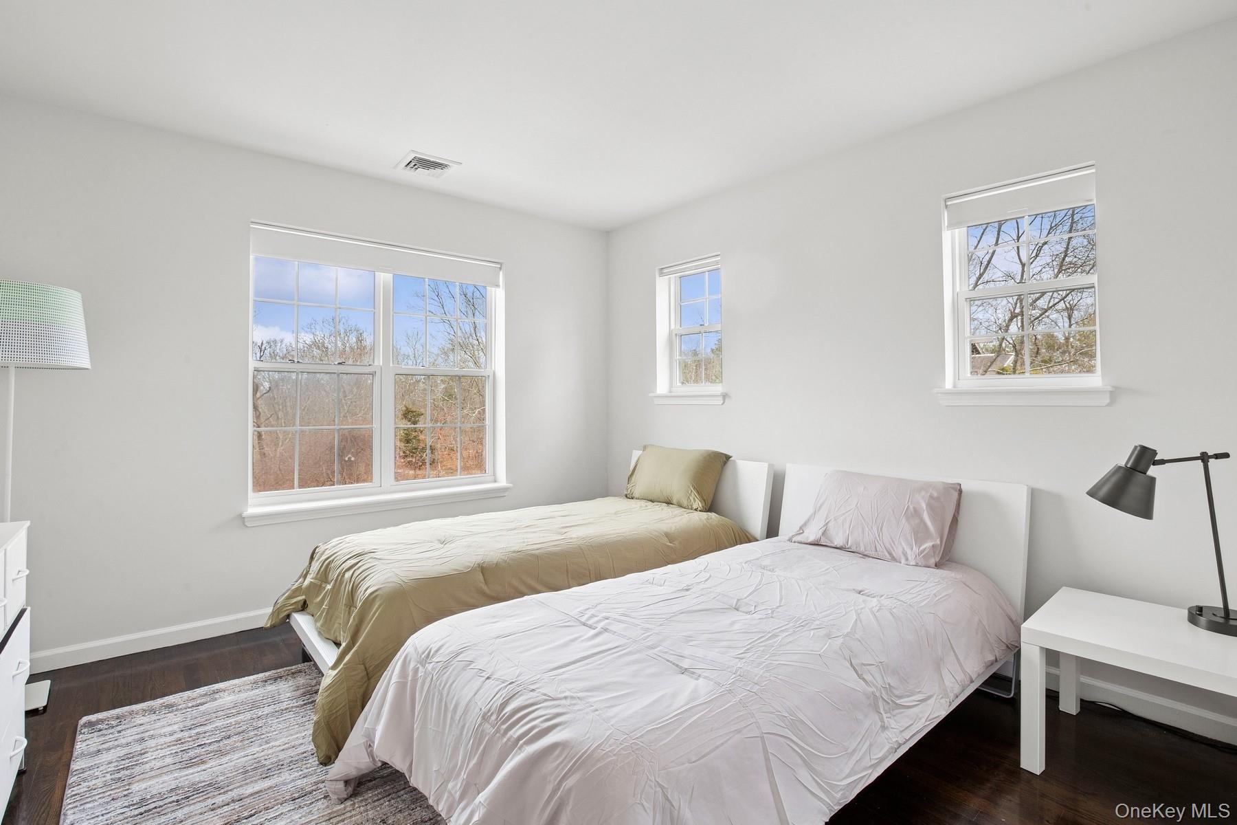 71 Old Canoe Place Road Hampton Bays, NY 11946 - Photo 22 of 34 a bedroom with a bed and a window