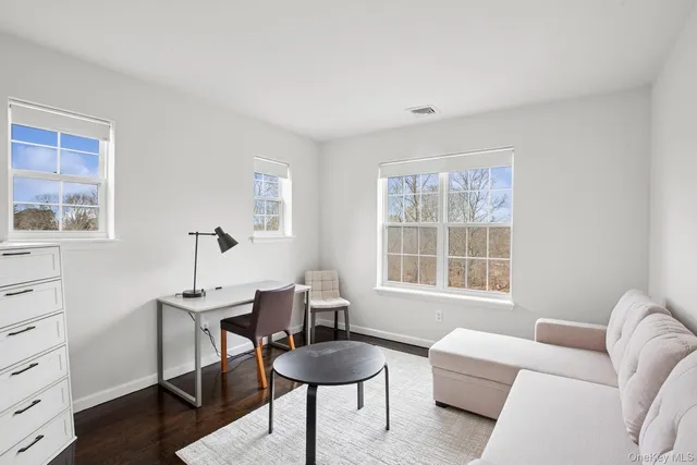 a living room with furniture a window and a lamp