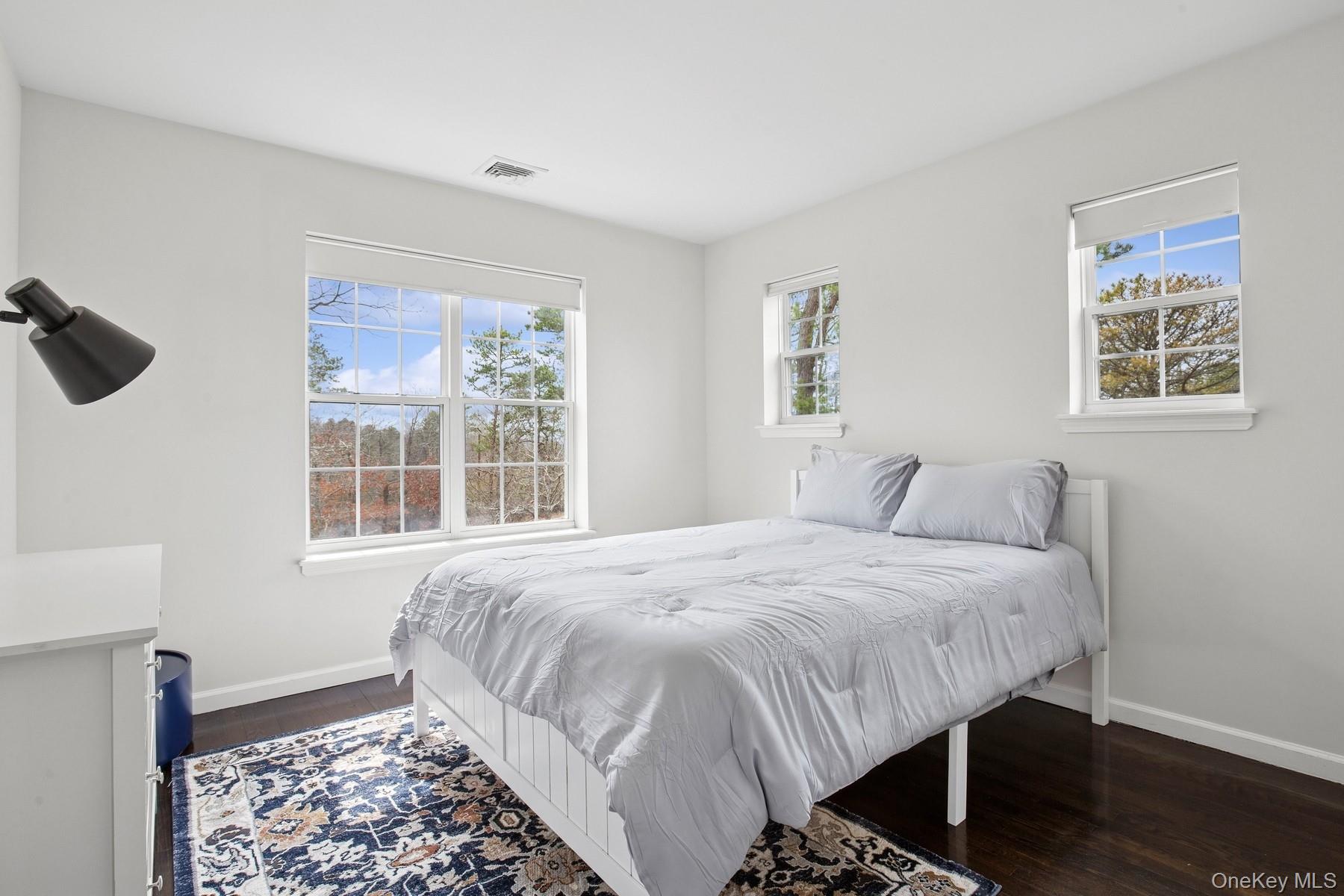 71 Old Canoe Place Road Hampton Bays, NY 11946 - Photo 27 of 34 a bedroom with a bed and a window