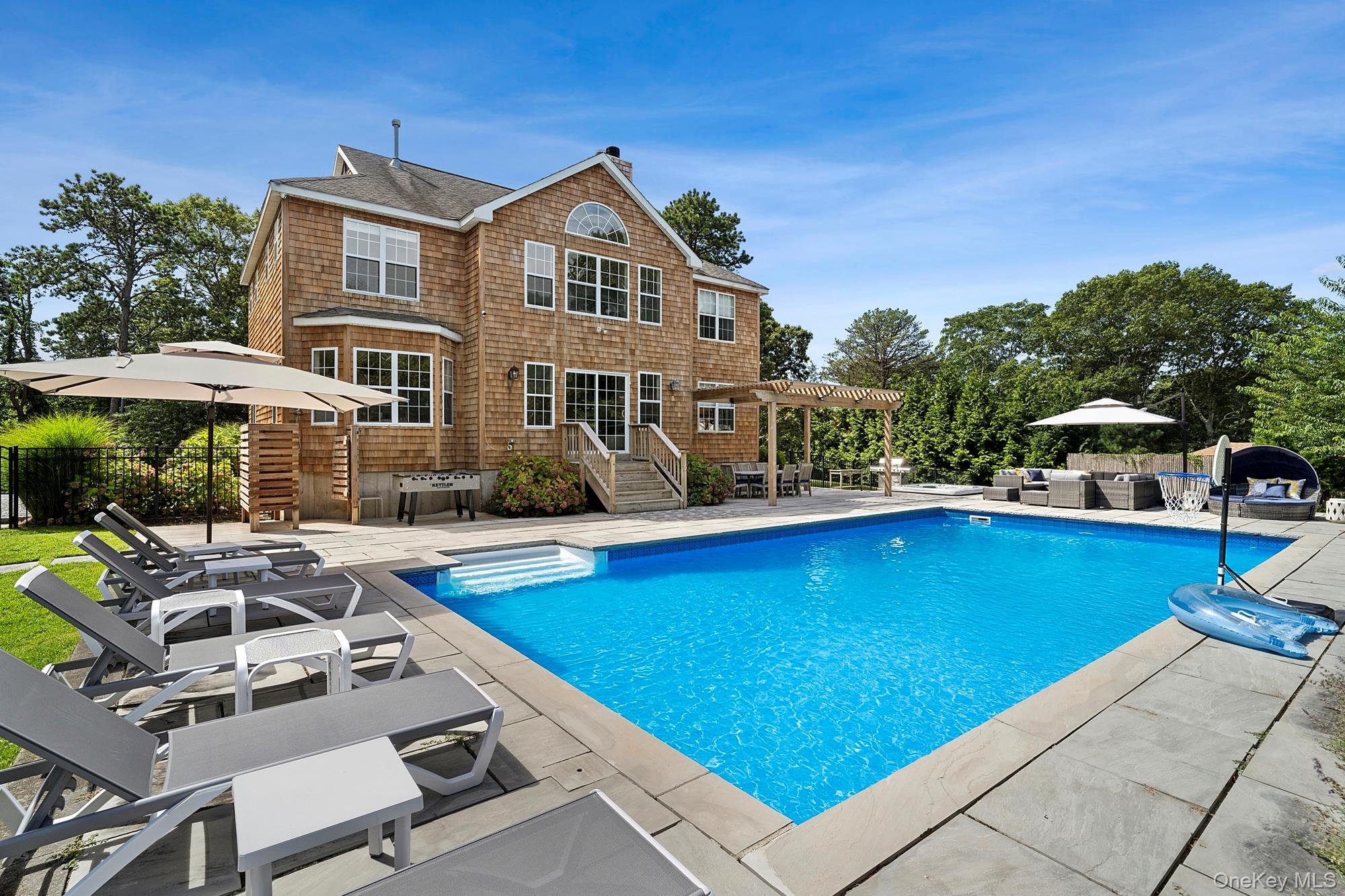 71 Old Canoe Place Road Hampton Bays, NY 11946 - Photo 30 of 34 a view of a swimming pool with lounge chairs