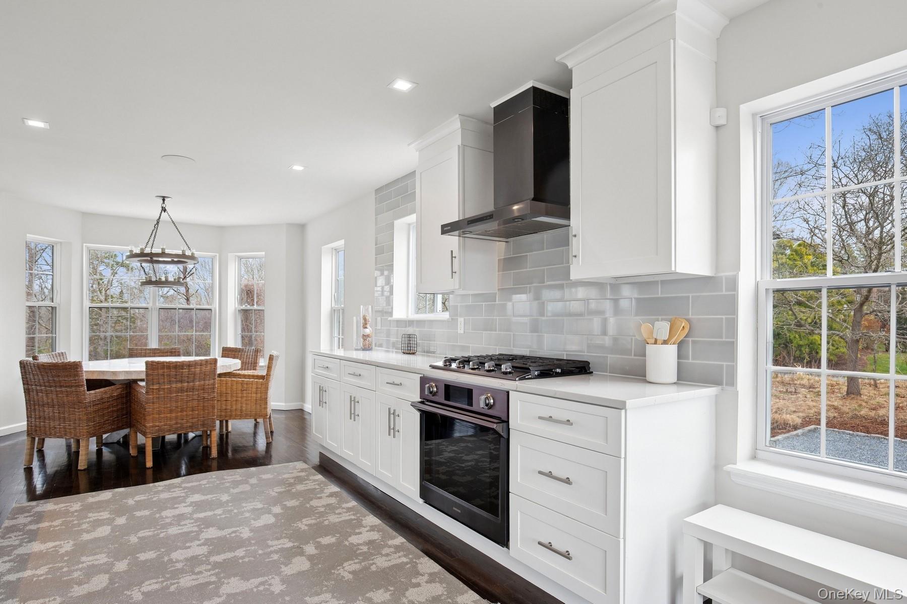71 Old Canoe Place Road Hampton Bays, NY 11946 - Photo 9 of 34 a kitchen with stainless steel appliances granite countertop a stove and a sink