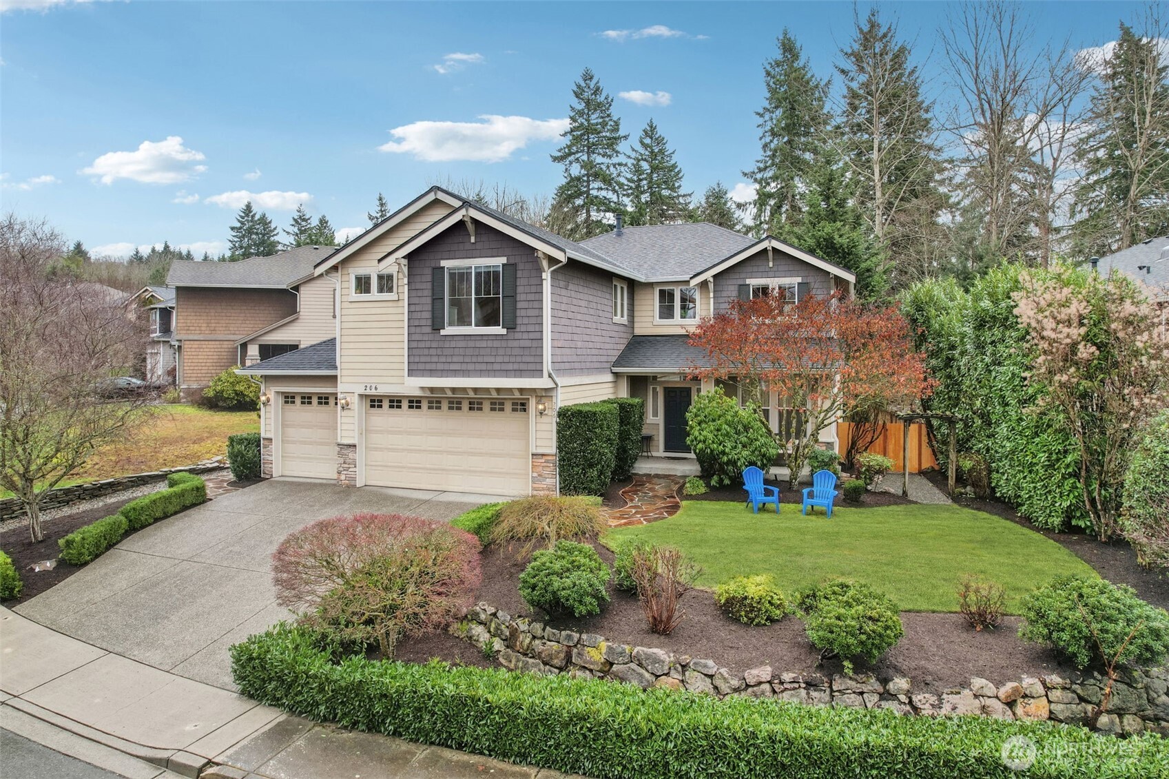a front view of a house with a yard and garage