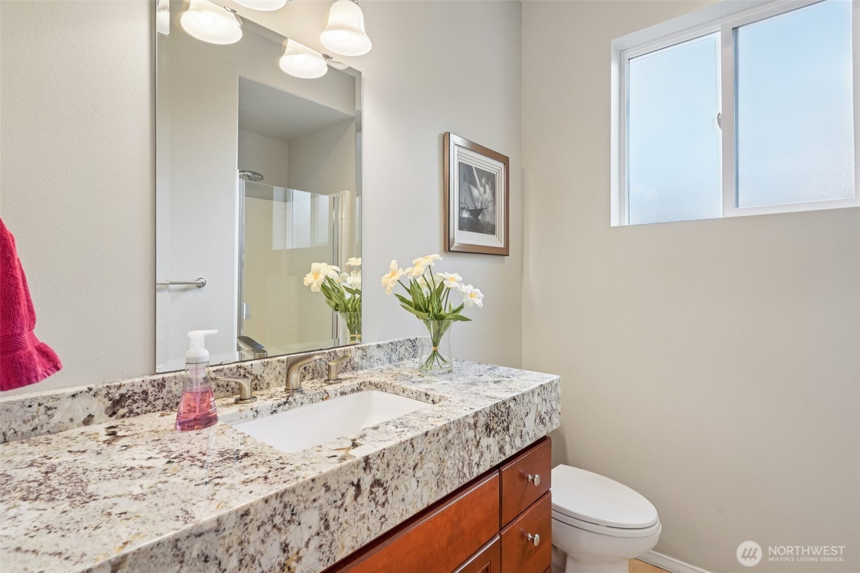 206 Pasco Drive Northeast Renton, WA 98059 - Photo 14 of 40 a bathroom with a granite countertop sink a toilet and mirror