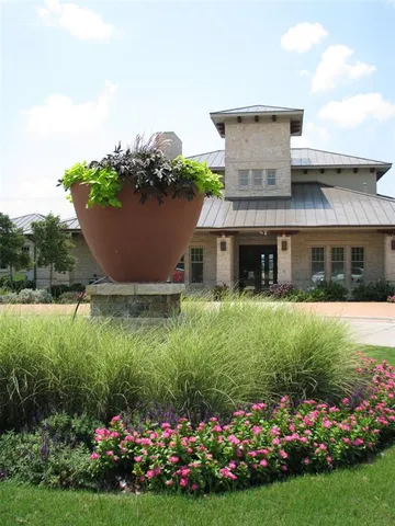 a front view of a house with a garden and yard