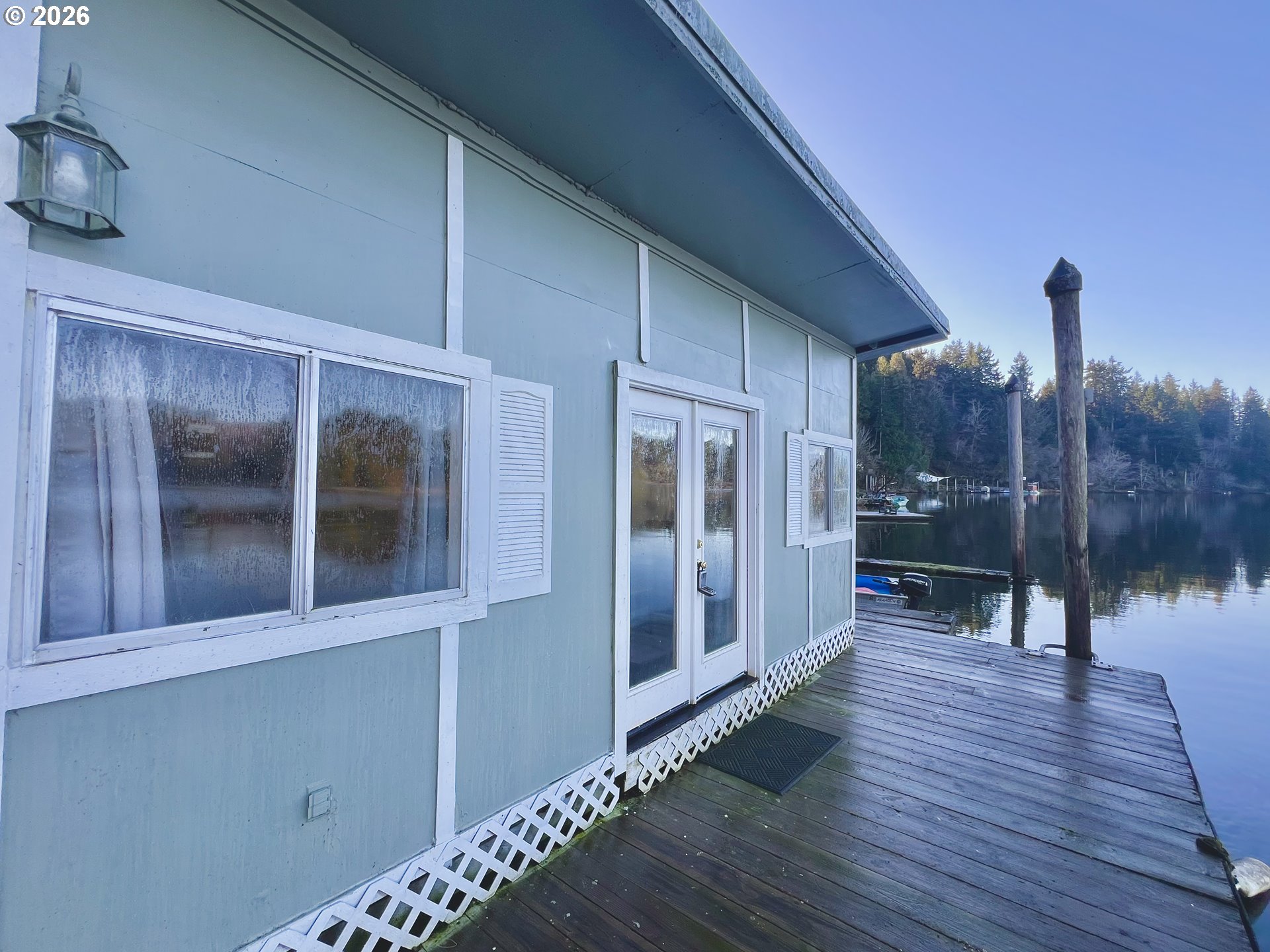 515 North Tenmile Lakeside, OR 97449 - Photo 1 of 20 a view of a room with wooden floor and a balcony