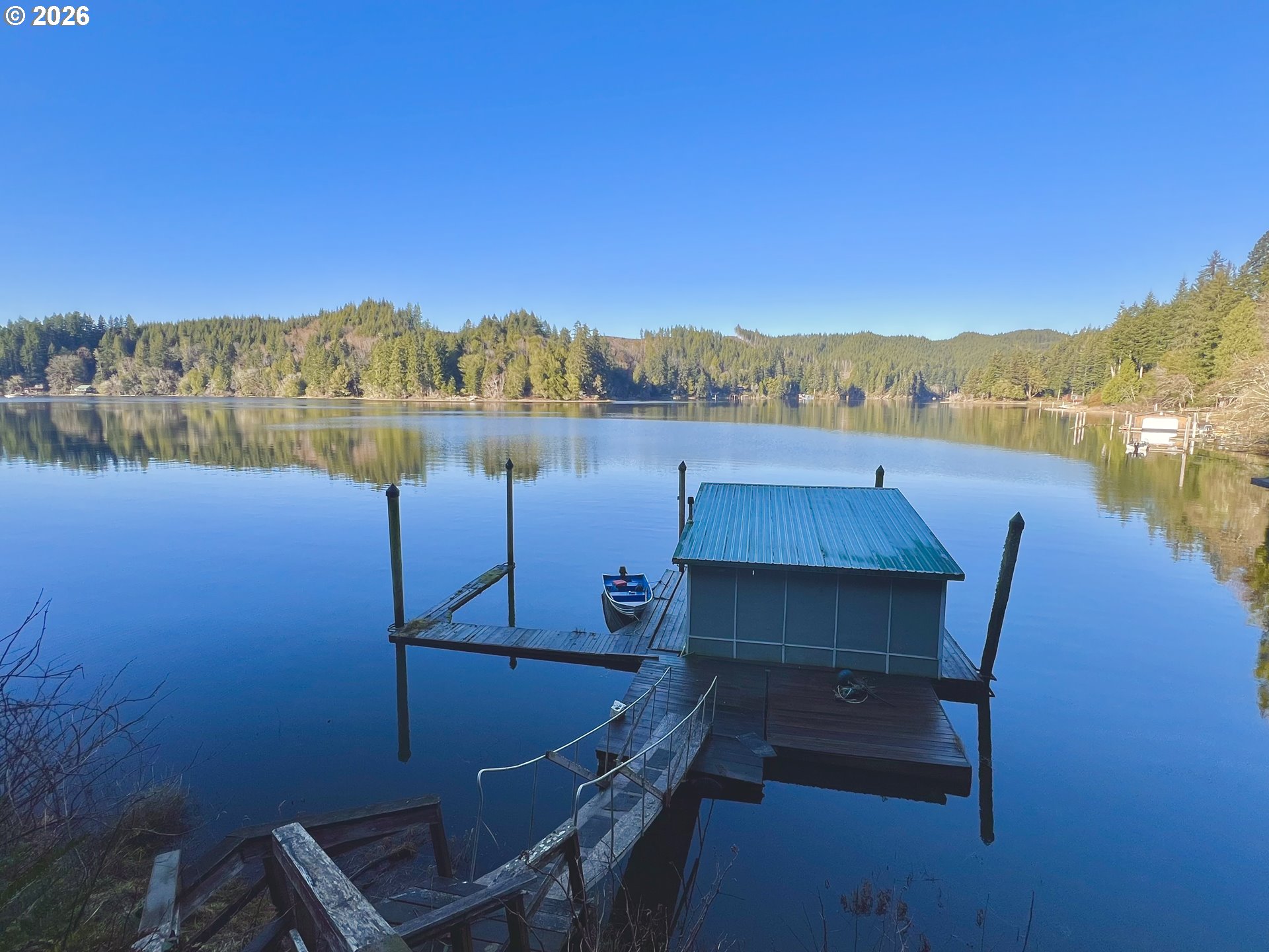 515 North Tenmile Lakeside, OR 97449 - Photo 15 of 20 a view of a lake with a mountain in the background