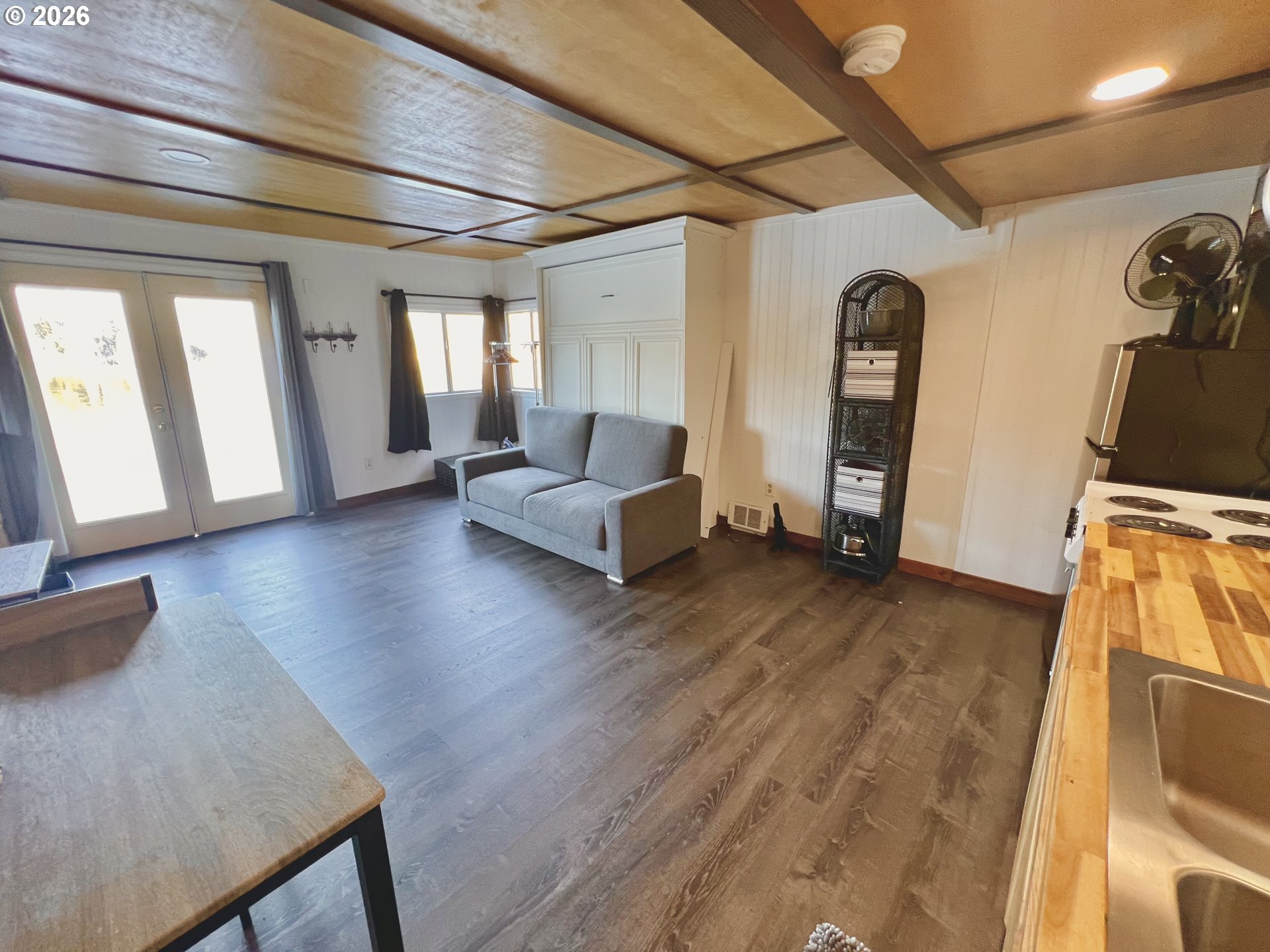 515 North Tenmile Lakeside, OR 97449 - Photo 7 of 20 a living room with furniture and a wooden floor
