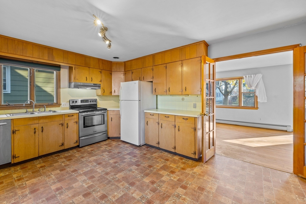 18 Huron Street Springfield, MA 01104 - Photo 7 of 35 a kitchen with refrigerator cabinets and wooden floor