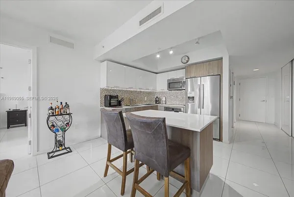 a kitchen with kitchen island cabinets and refrigerator