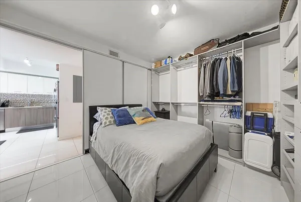 a bedroom with a bed and a walk in closet