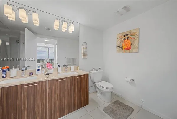 a bathroom with a sink mirror vanity and toilet