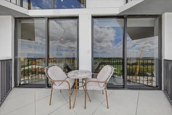 a view of a patio with a table and chairs