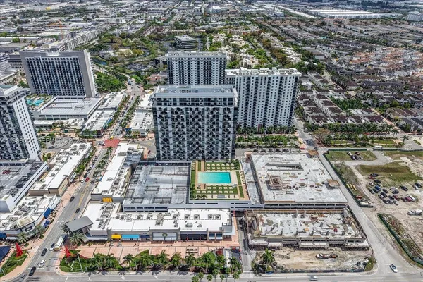 an aerial view of a residential houses with outdoor space
