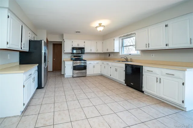 a kitchen with cabinets and appliances