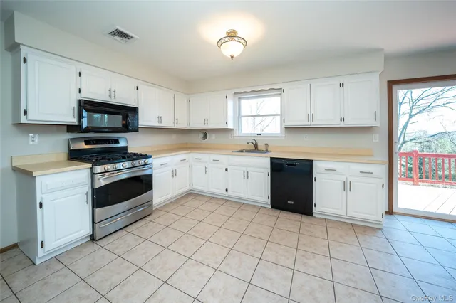 a kitchen with a stove sink and a microwave