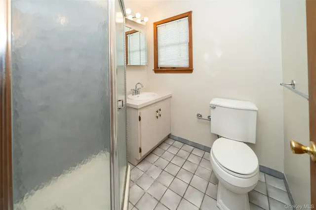 a white toilet sitting next to a bathroom sink