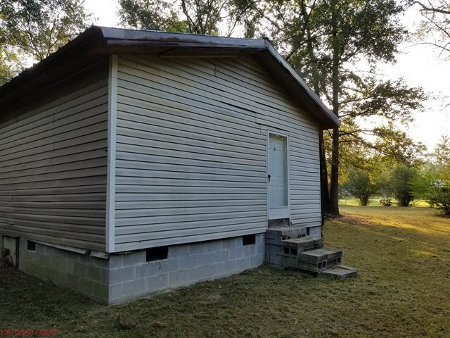 65 Childres Road Roberta, GA 31078 - Photo 14 of 17 a view of a small house with a yard and wooden fence