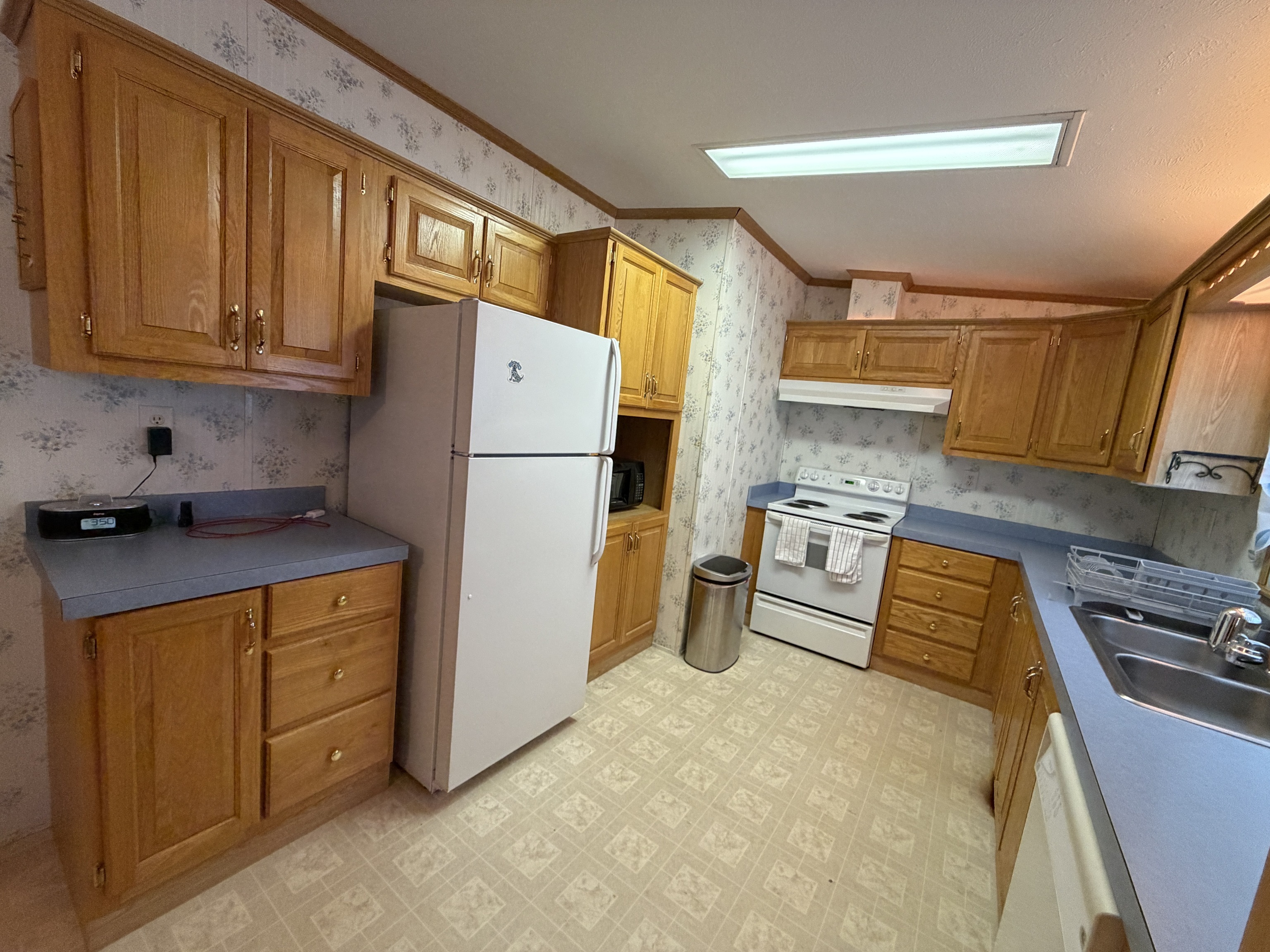 16 3rd Street Beacon Falls, CT 06403 - Photo 8 of 12 a kitchen with a refrigerator and a stove top oven