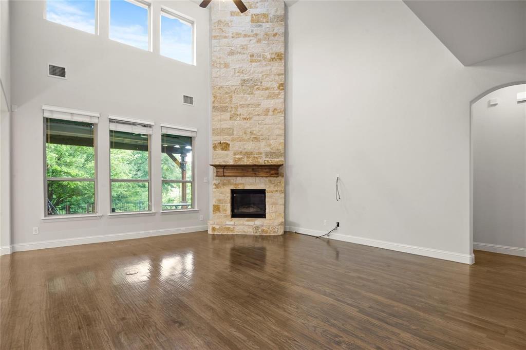 13606 Crianza Road Frisco, TX 75035 - Photo 11 of 40 an empty room with wooden floor and a fireplace