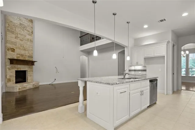 a kitchen with a sink a stove and a refrigerator