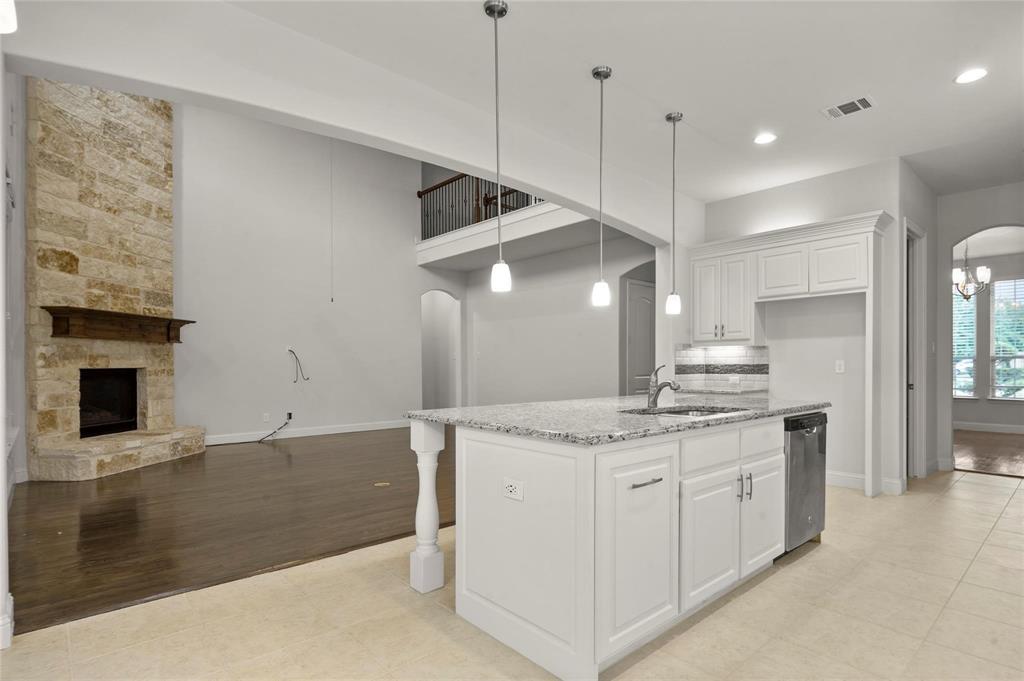 13606 Crianza Road Frisco, TX 75035 - Photo 14 of 40 a kitchen with a sink a stove and a refrigerator