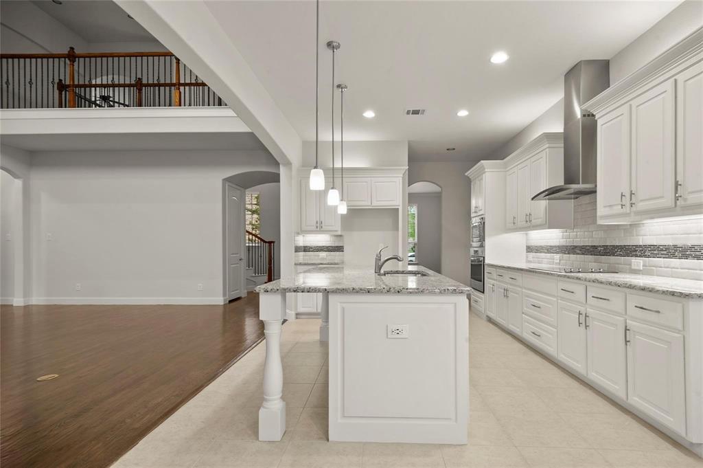 13606 Crianza Road Frisco, TX 75035 - Photo 20 of 40 a kitchen with stainless steel appliances granite countertop a sink a stove and a refrigerator